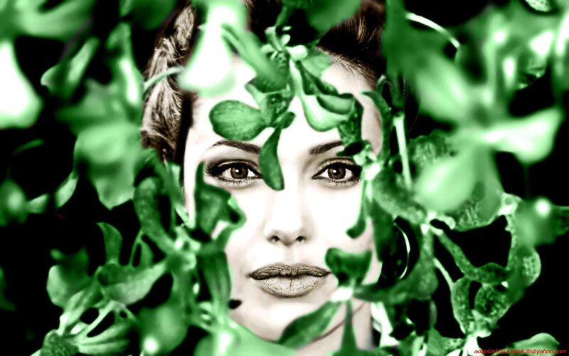 woman behind green leaves