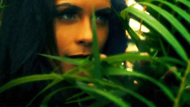 Woman Behind Green Leaves — Dramatic