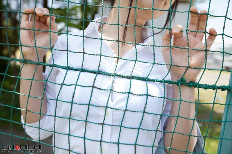 woman behind green net