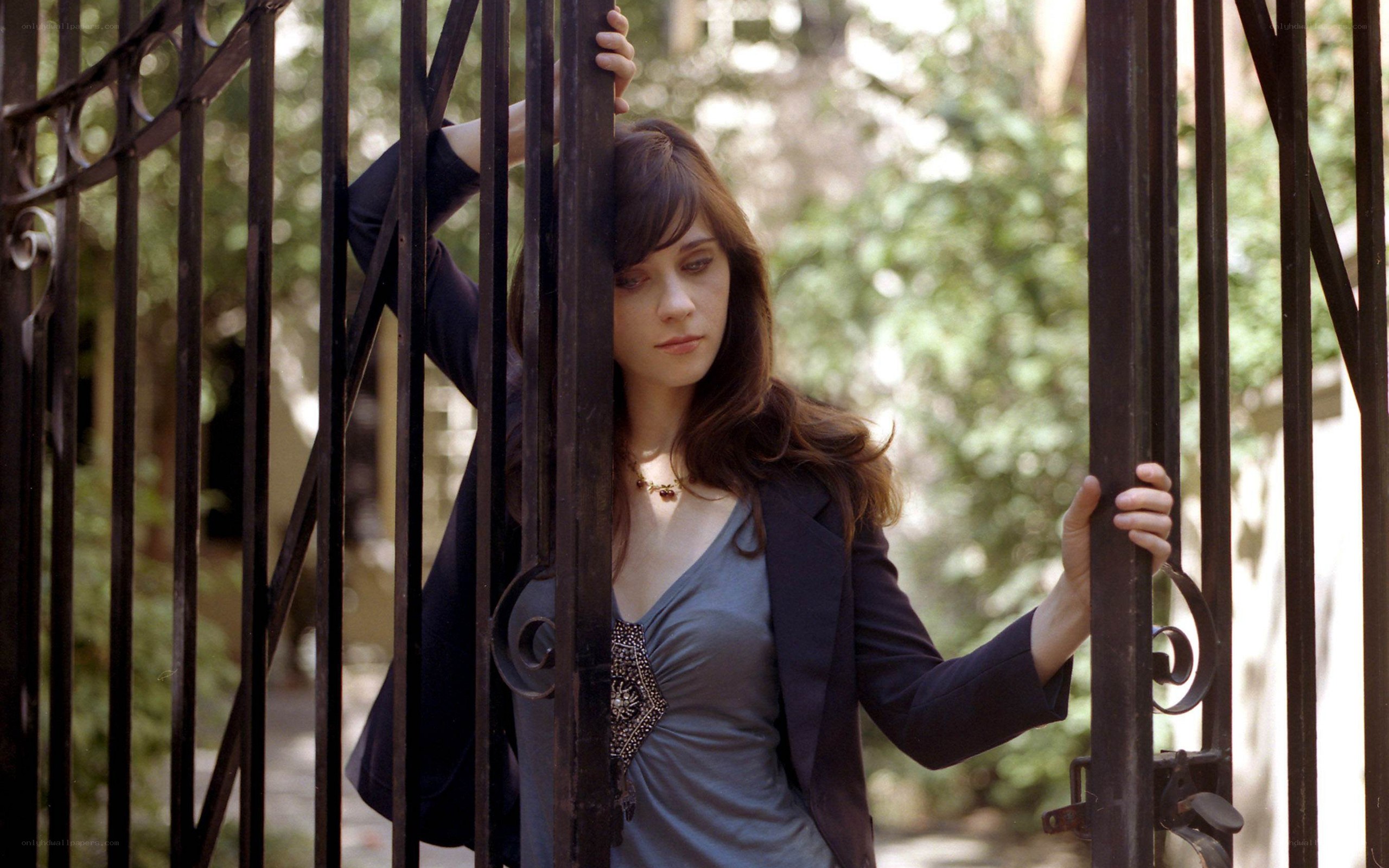 woman behind iron gate