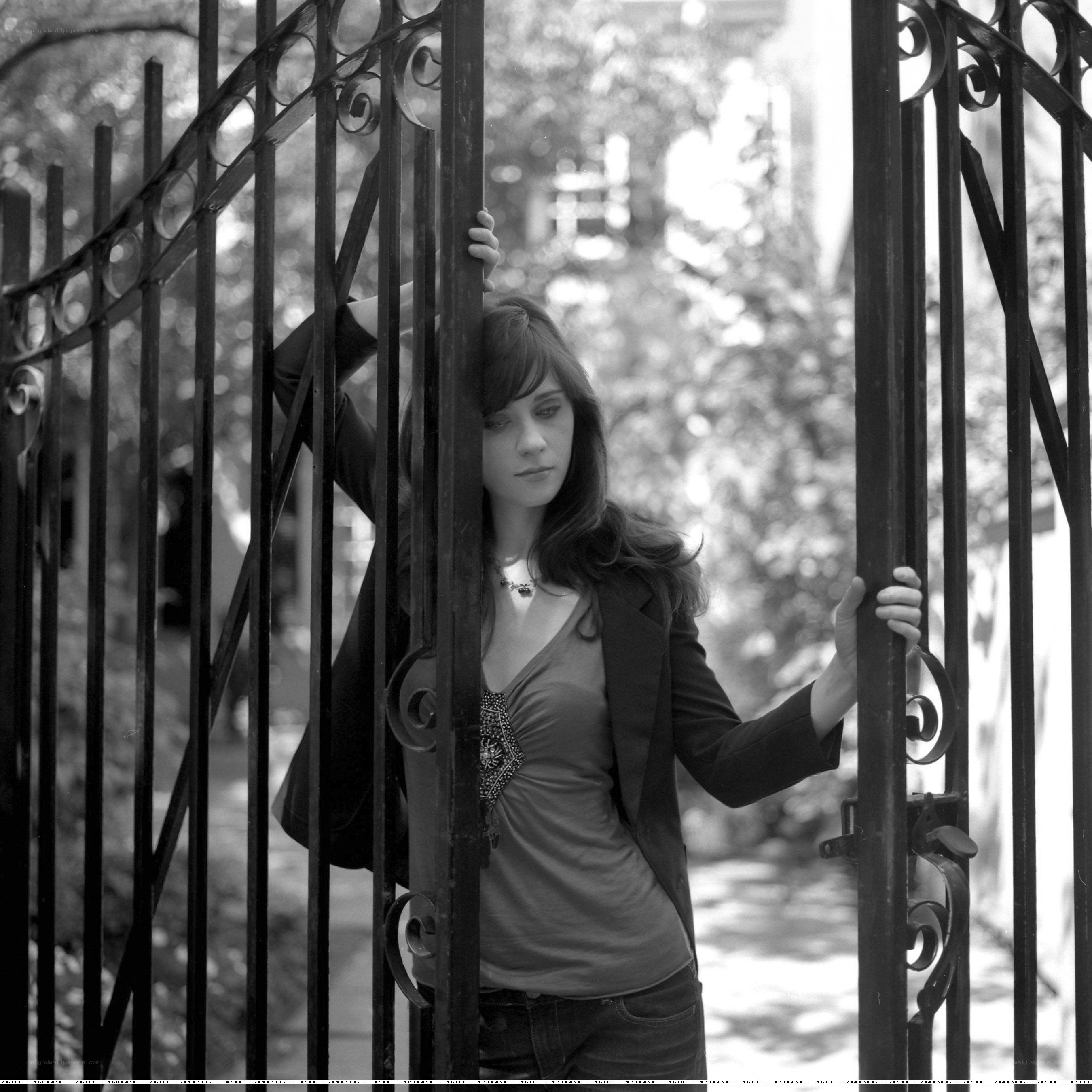woman behind iron gate