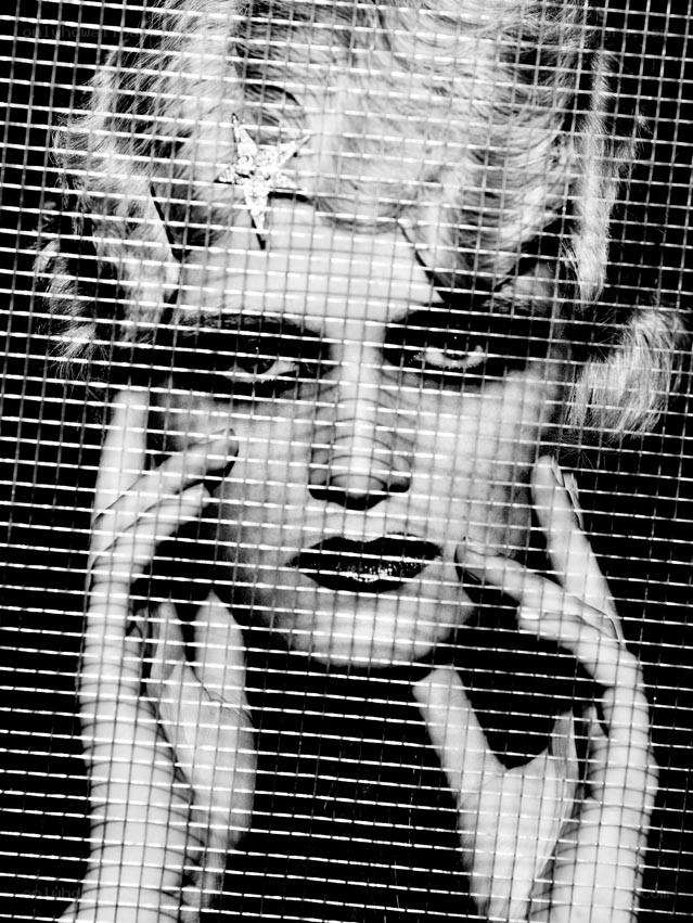 woman behind mesh screen