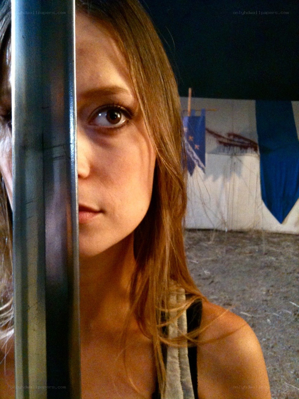 woman behind metal bar