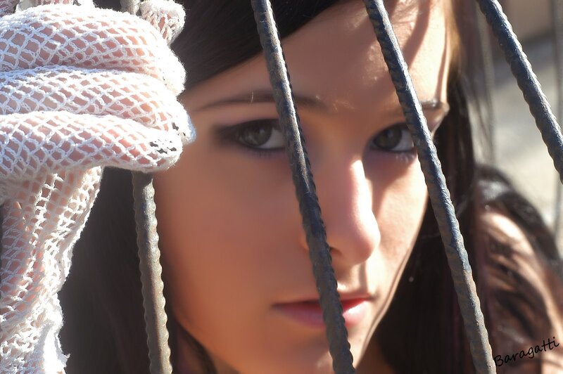 woman behind metal bars