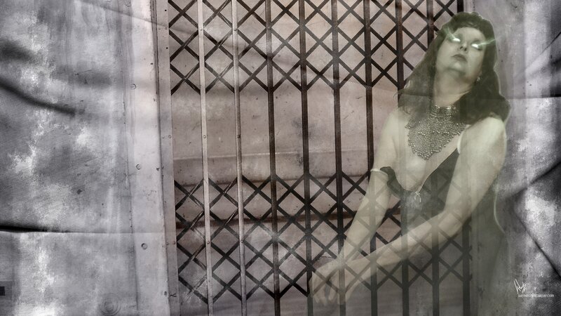woman behind metal gate
