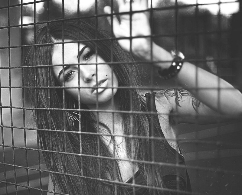 woman behind metal grid