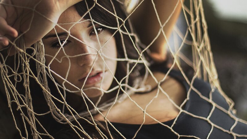 Woman Behind Net — Brown, Dramatic