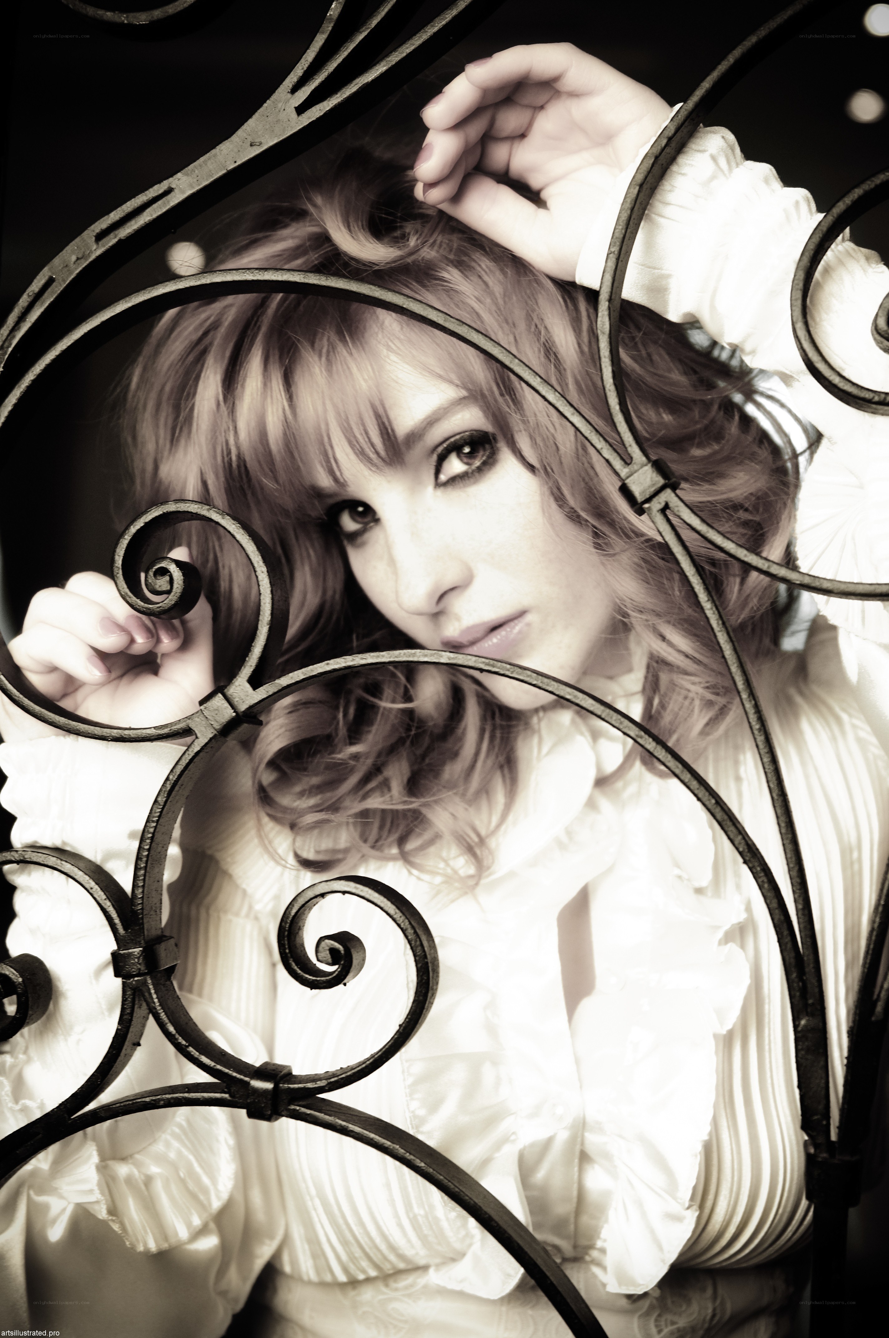 woman behind ornate gate