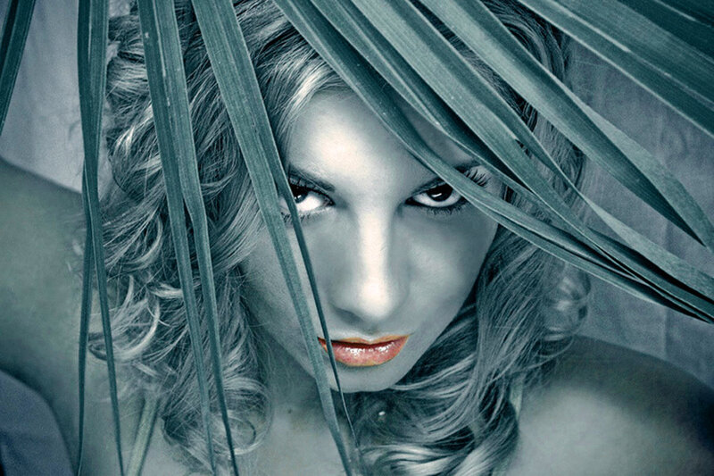 woman behind palm leaves