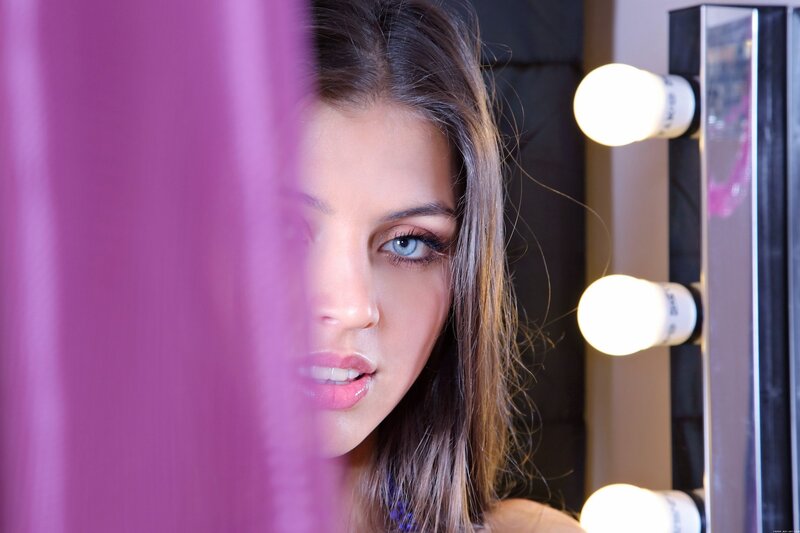 woman behind purple curtain