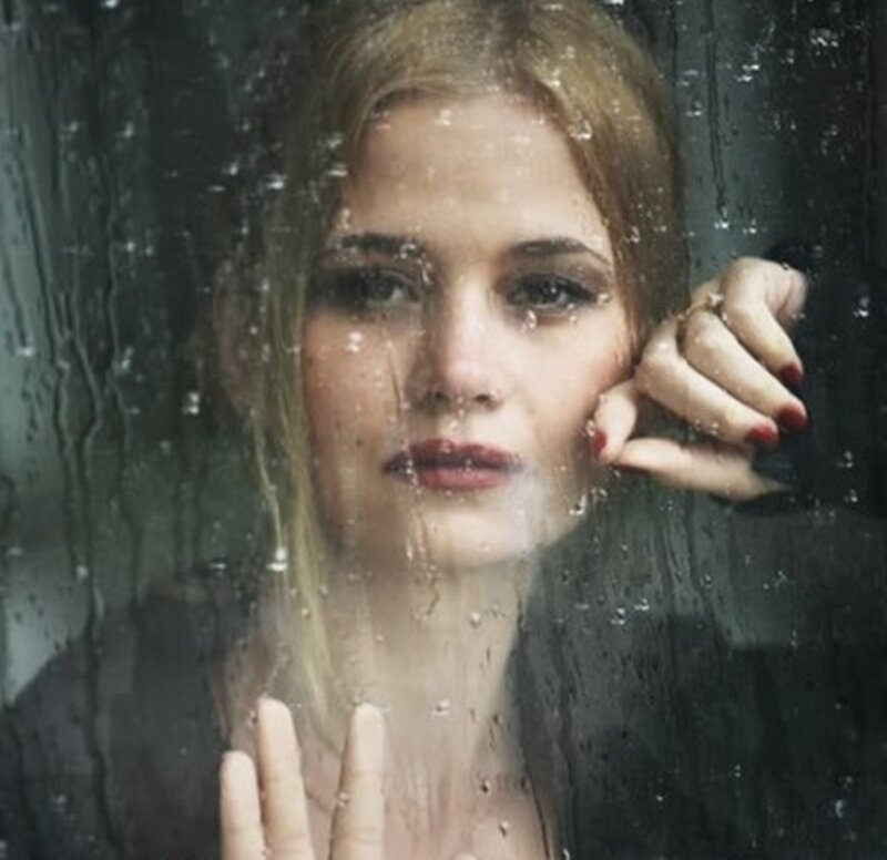 Woman Behind Rain-covered Glass — Gray