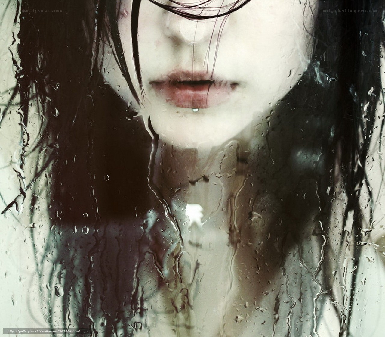 woman behind rain-streaked glass