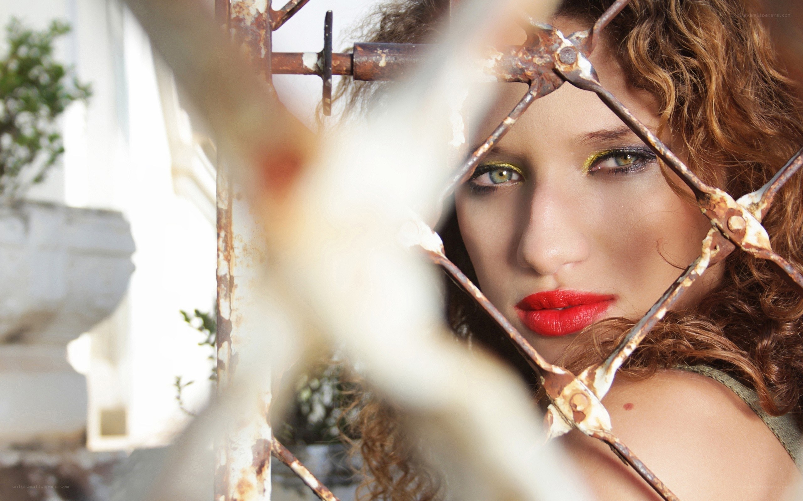 woman behind rusty gate