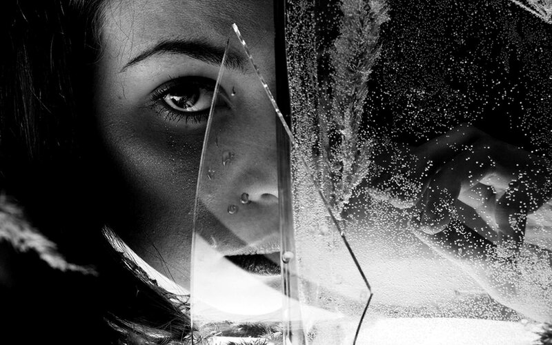 woman behind shattered glass