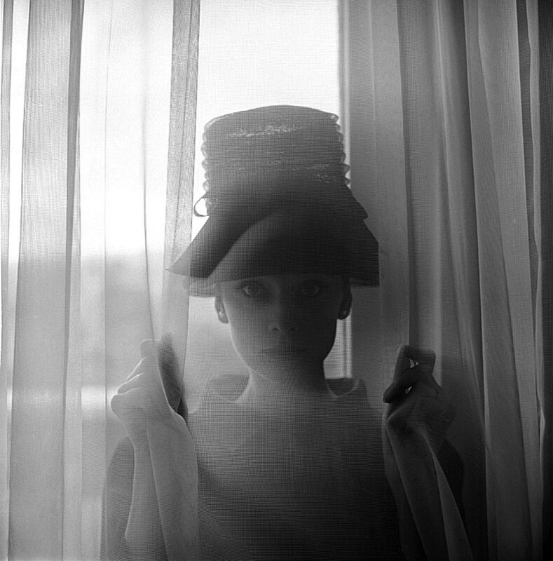 woman behind sheer curtain