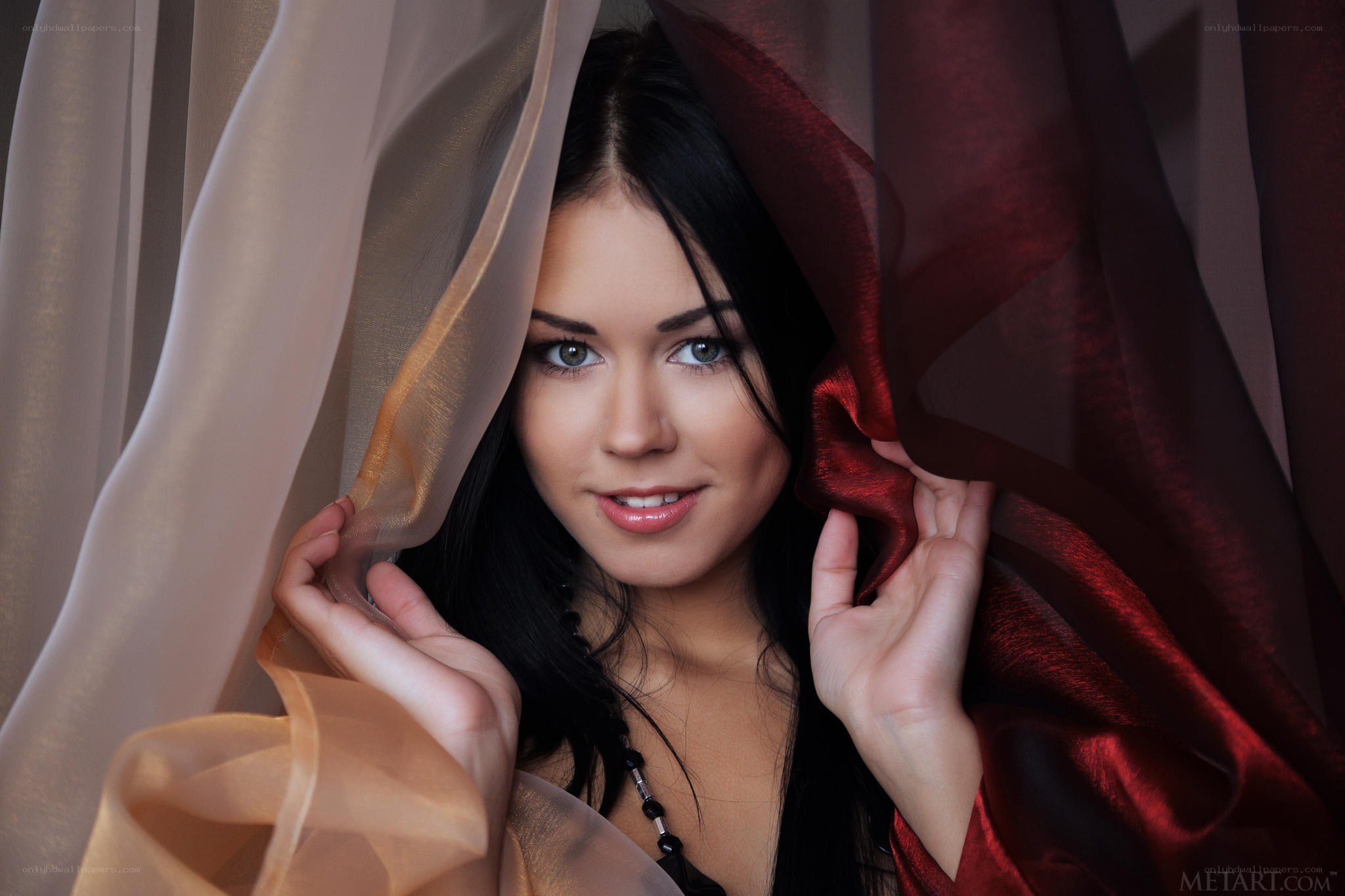 woman behind sheer curtains