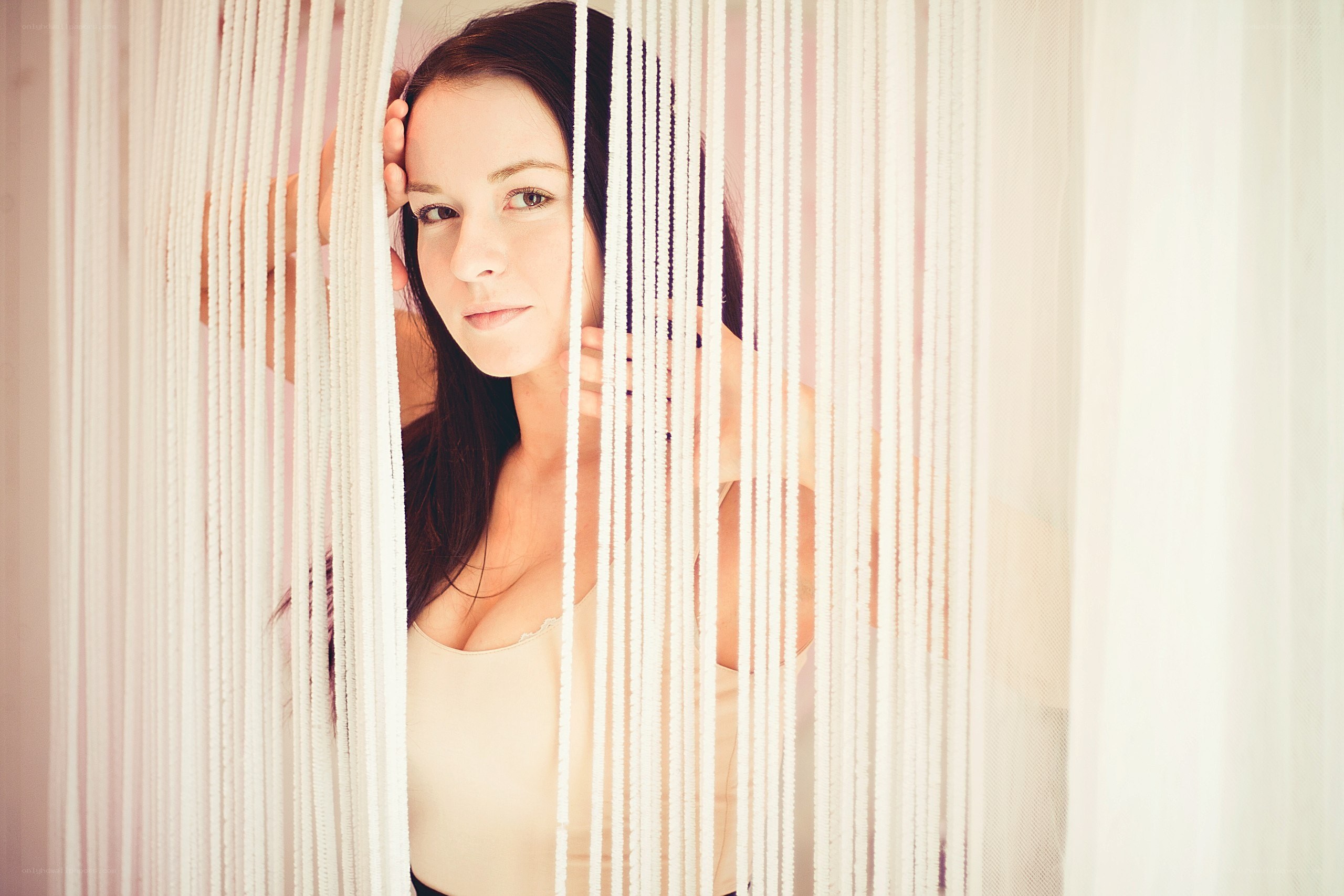 woman behind string curtain