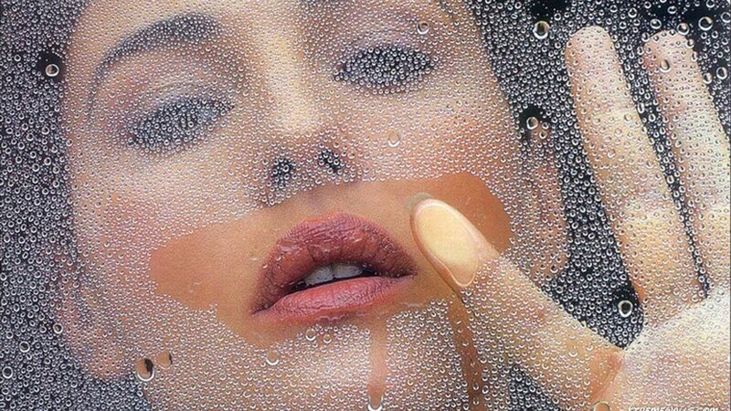 woman behind water droplets