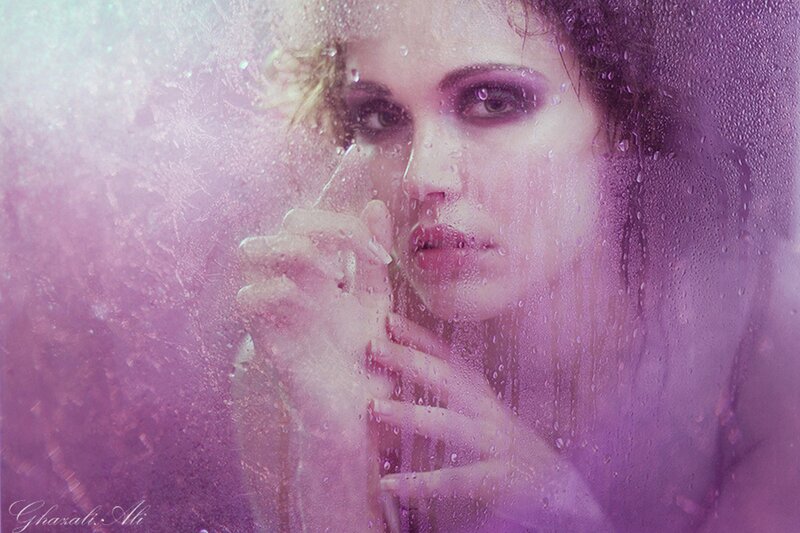 woman behind wet glass