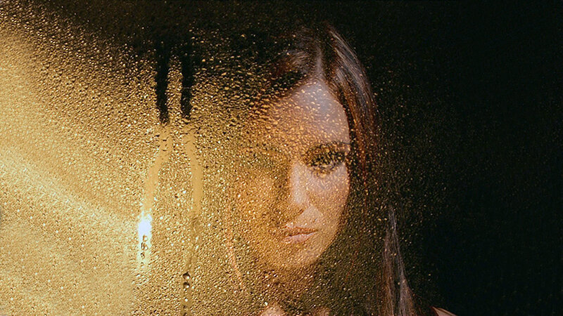 Woman Behind Wet Glass — Gold, Dramatic