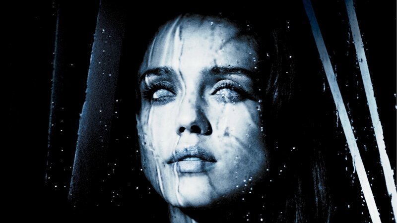 woman behind wet glass