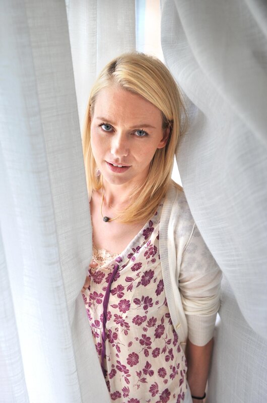 woman behind white curtain