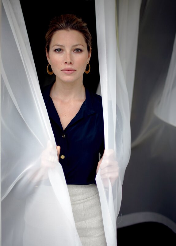 woman behind white curtain