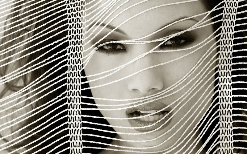 woman behind white net