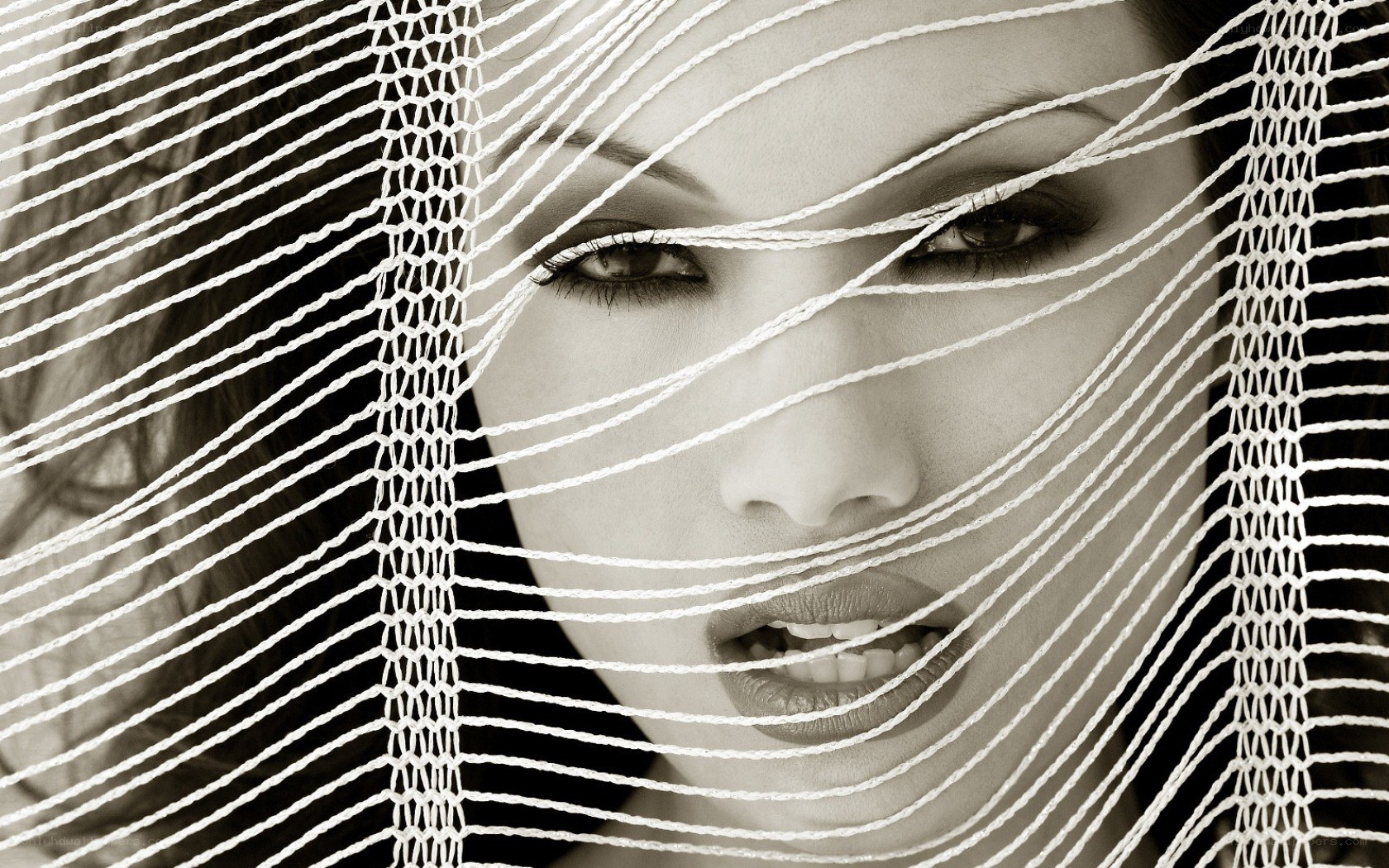 woman behind white net