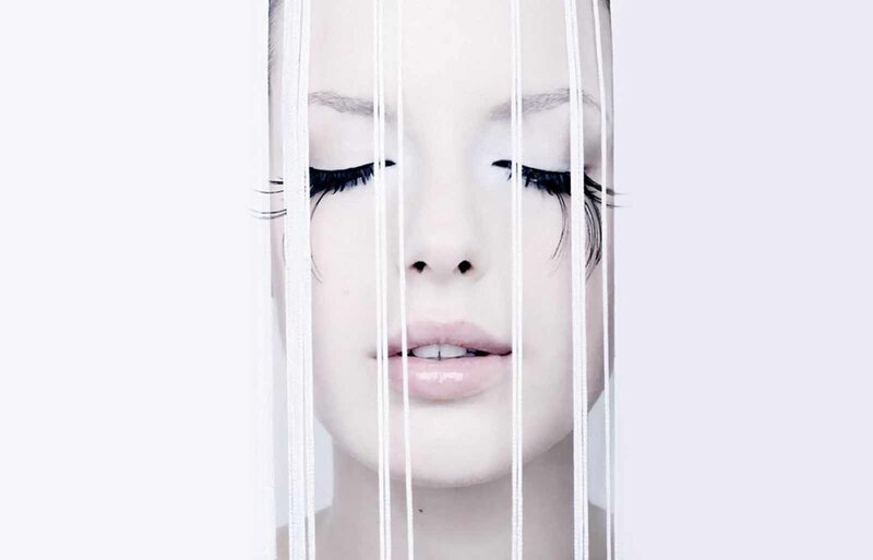 woman behind white strings