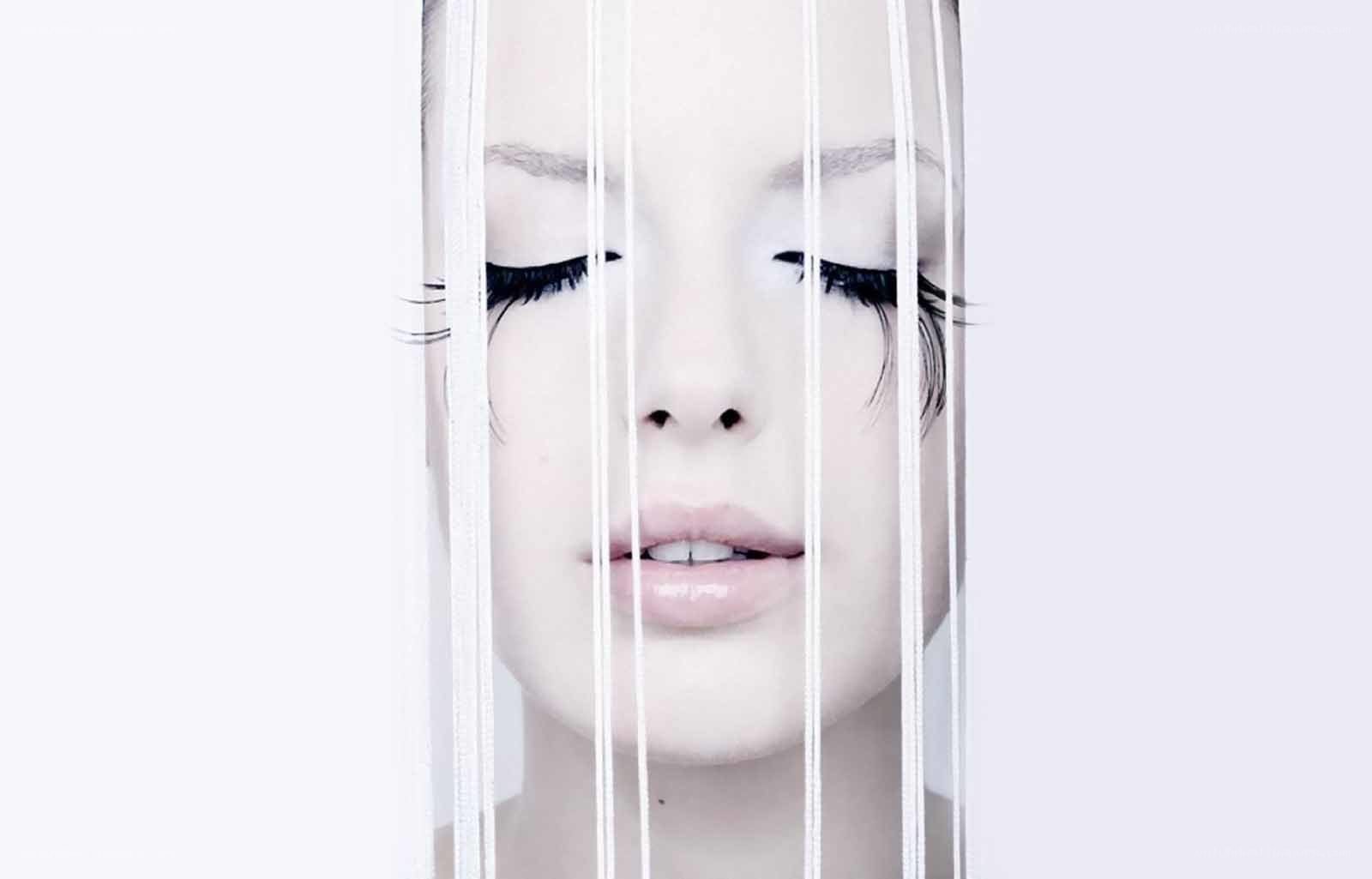 woman behind white strings
