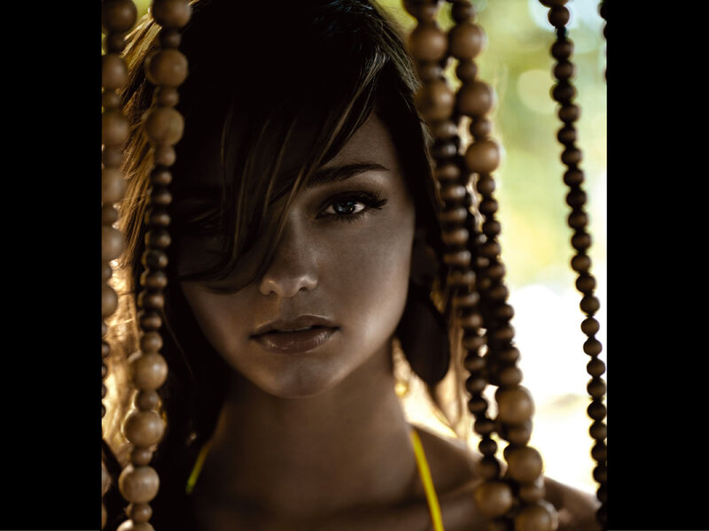 woman behind wooden beads
