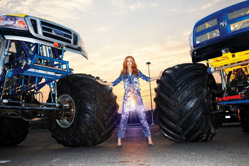 Woman Between Monster Trucks