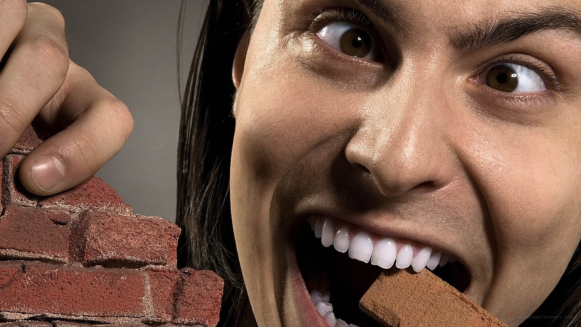 woman biting brick