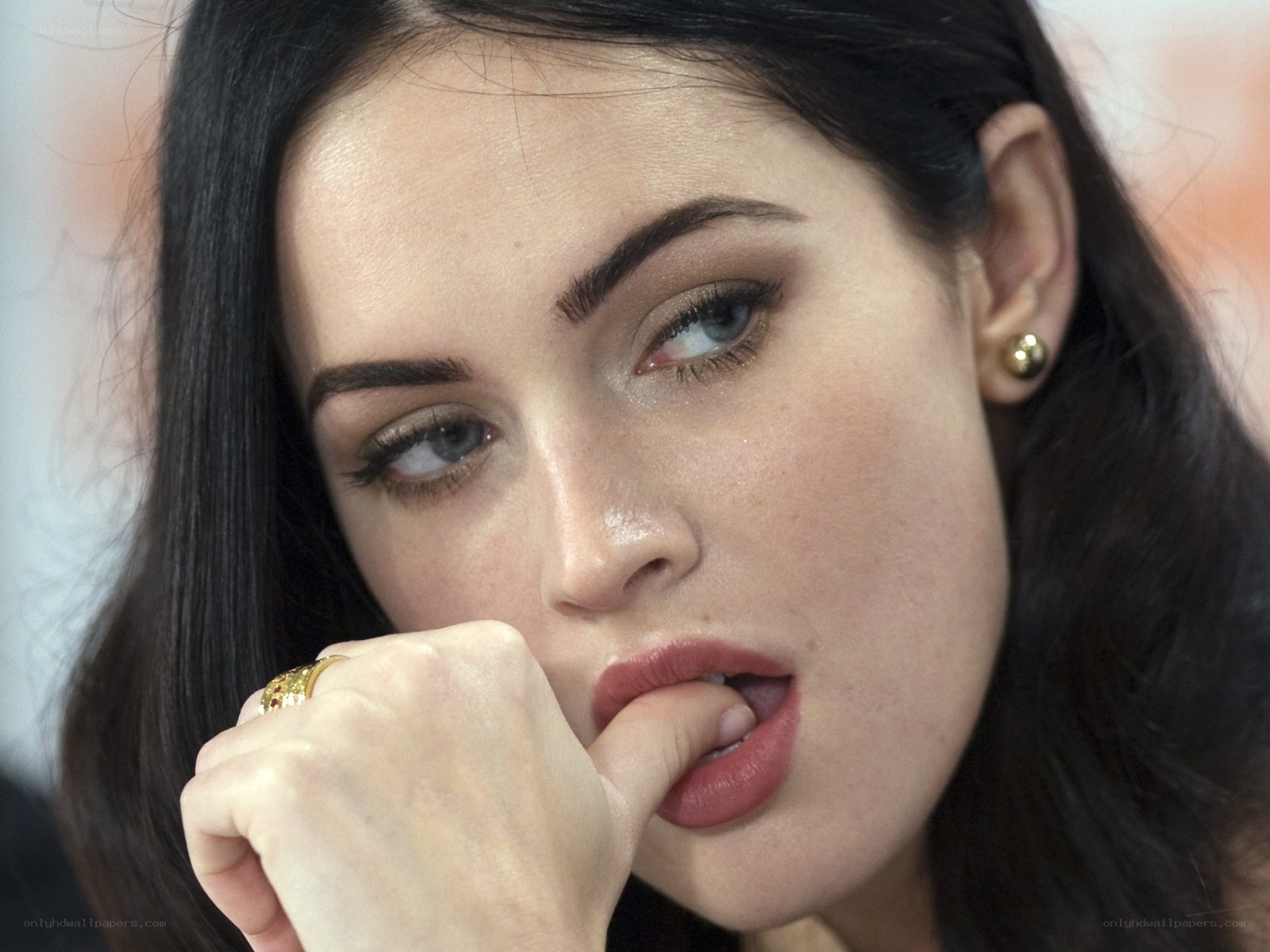 woman biting finger thoughtfully