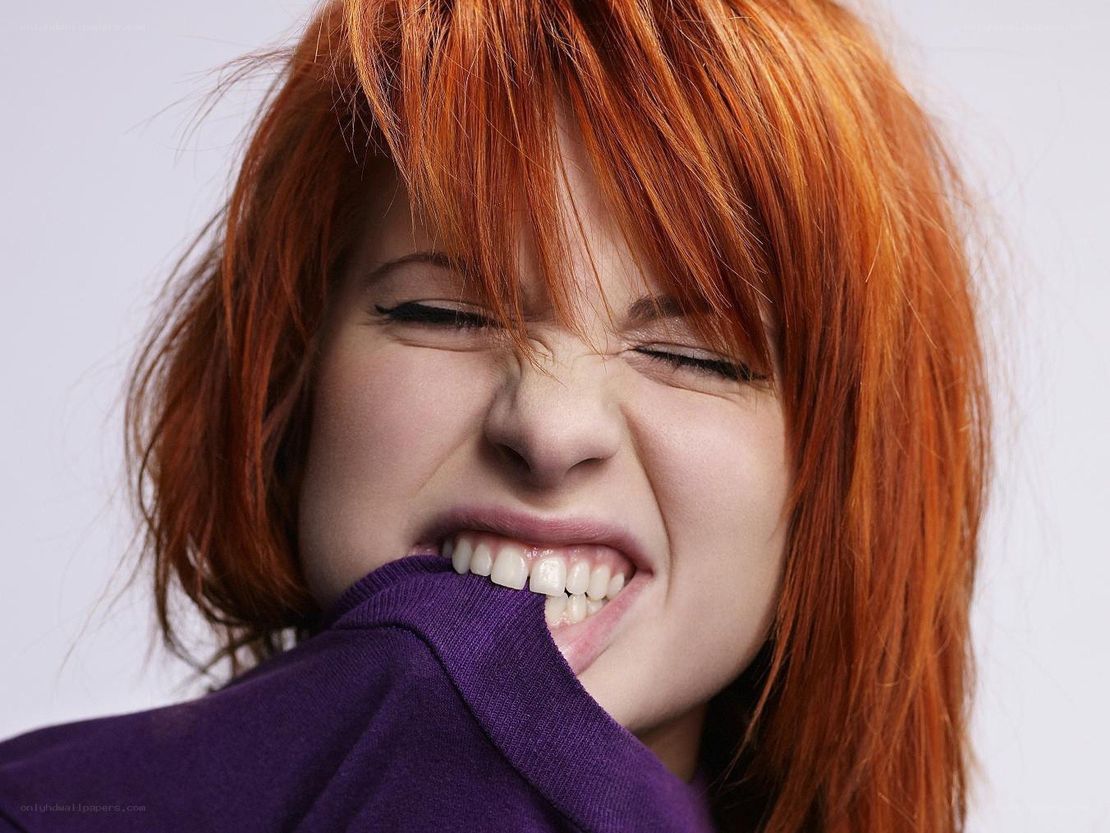 woman biting her sweater