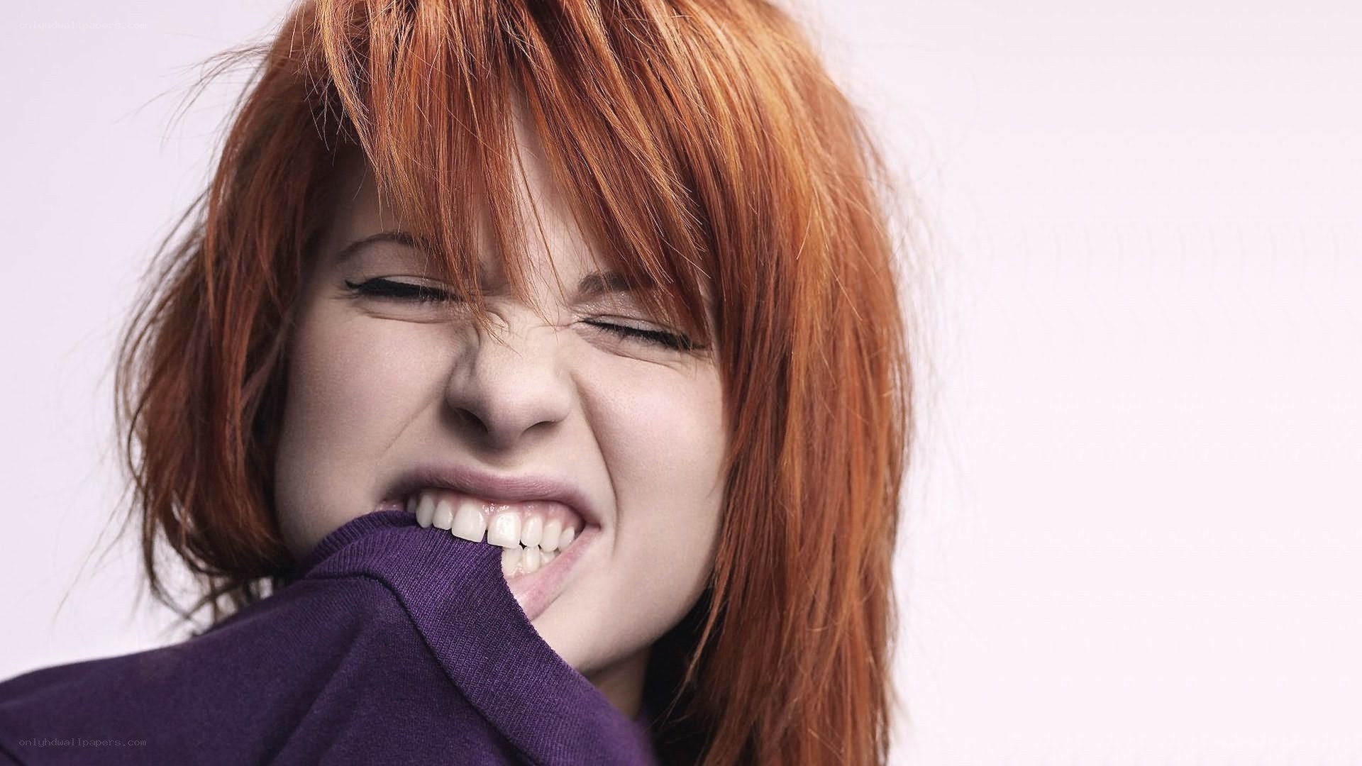 woman biting her sweater