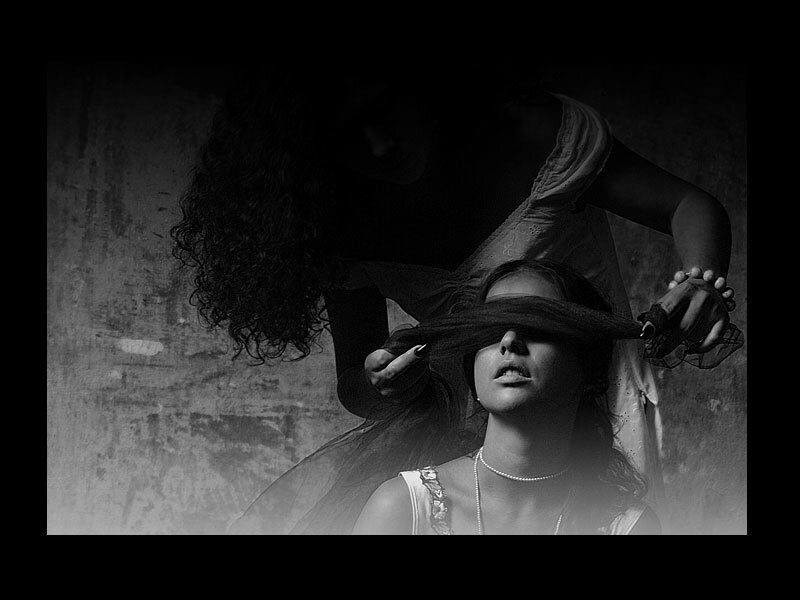 Woman Blindfolding Another