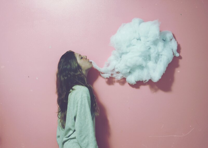 woman blowing a cloud