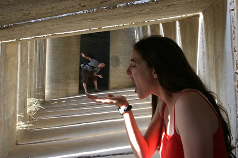 Woman Blowing Air at Man