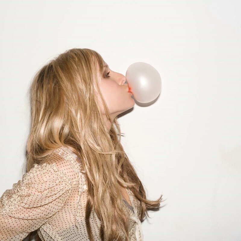 woman blowing bubble gum