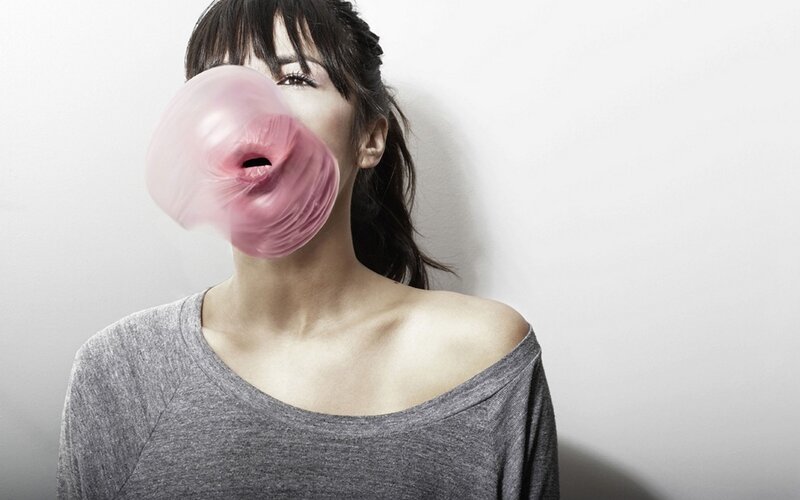 woman blowing bubble gum