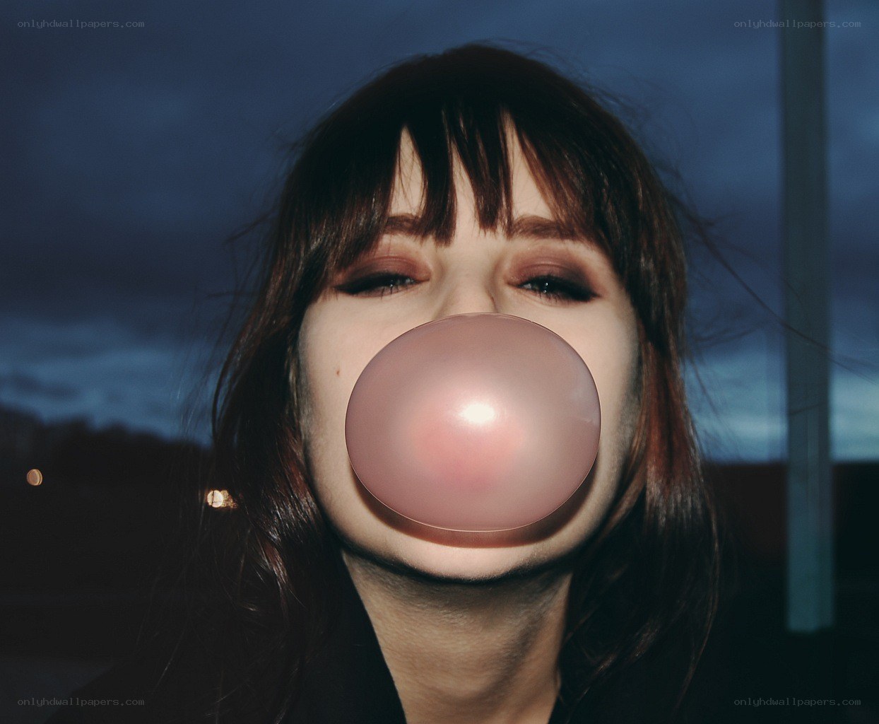 woman blowing bubble gum