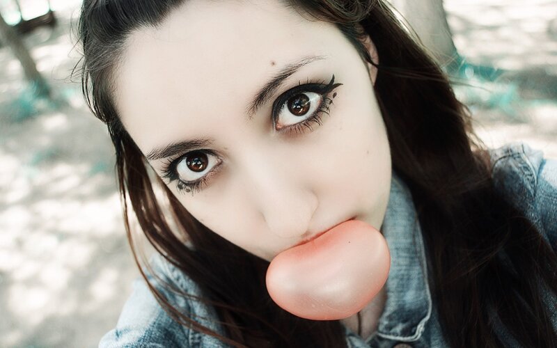 woman blowing bubble gum