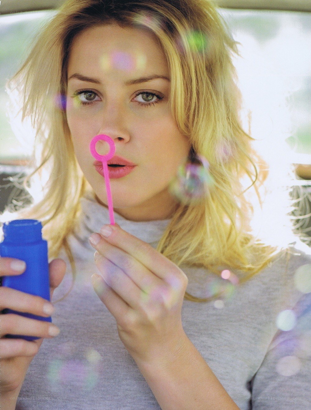 woman blowing bubbles