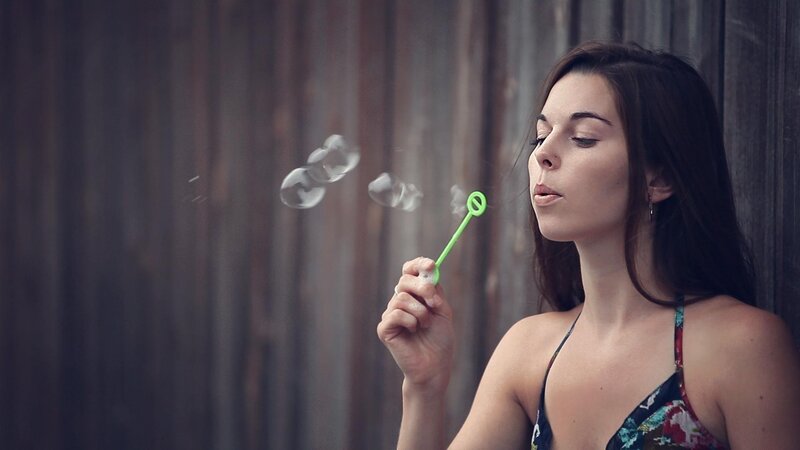 woman blowing bubbles