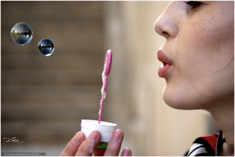 woman blowing bubbles