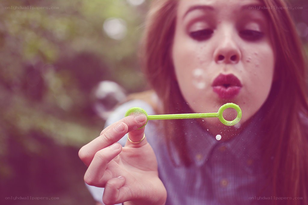 woman blowing bubbles