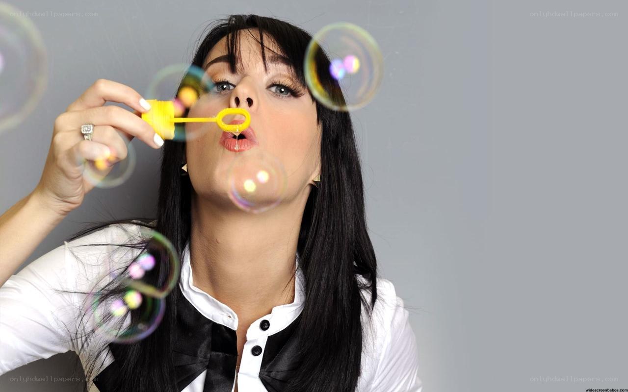 woman blowing bubbles
