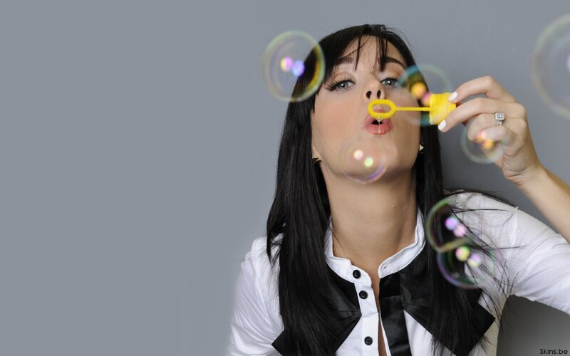 woman blowing bubbles